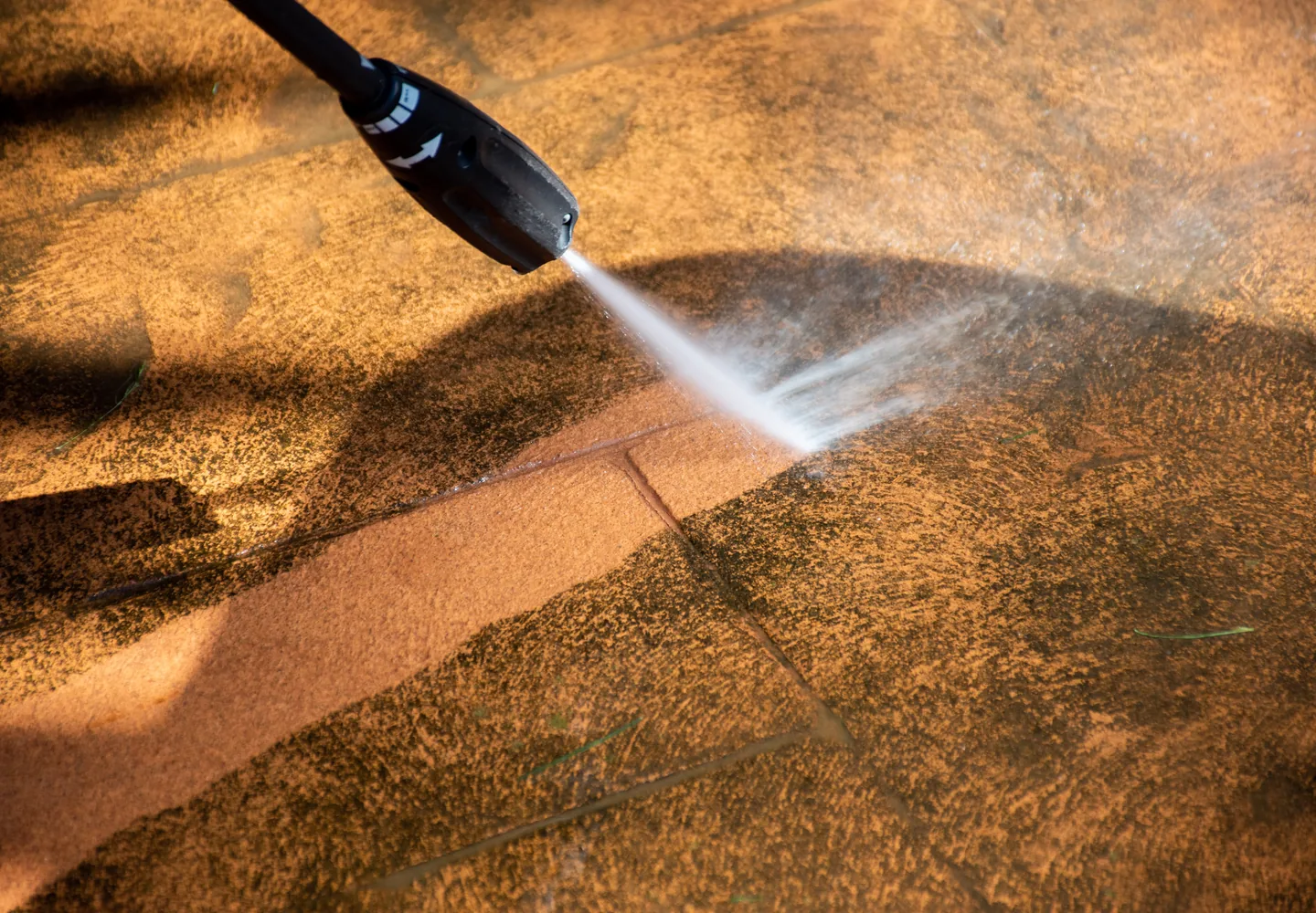 Pressure washer cleaning an outdoor patio